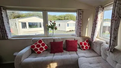 a living room with a couch with red pillows at Willerby Seasons in Morecambe