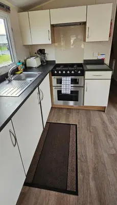 a kitchen with a stove and a sink at Willerby Seasons in Morecambe