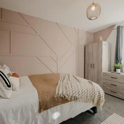 a bedroom with a bed with a geometric wall at Cosy New Brighton Room for Rent in New Brighton