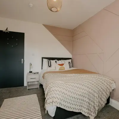 a bedroom with a large bed in a attic at Cosy New Brighton Room for Rent in New Brighton