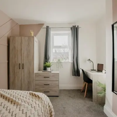 a bedroom with a bed and a desk and a window at Cosy New Brighton Room for Rent in New Brighton