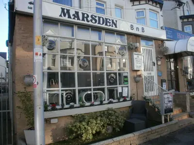 a store front with a large window on a street at Marsden B&B in Blackpool