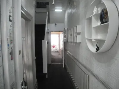 a hallway with a mirror on a wall at Marsden B&B in Blackpool