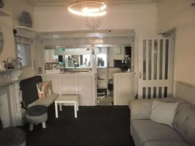 a living room with a couch and a table at Marsden B&B in Blackpool