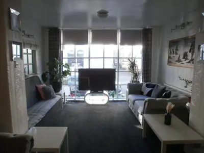 a living room with a couch and a tv at Marsden B&B in Blackpool