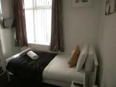 a bed in a small room with a window at Marsden B&B in Blackpool