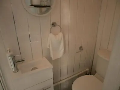 a small bathroom with a toilet and a sink at Marsden B&B in Blackpool