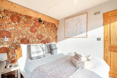 a bedroom with a wooden accent wall and a bed at 1 Bed in Newton In Bowland oc-h34064 in Newton