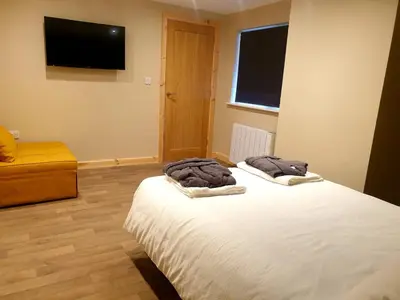 a bedroom with a bed with two towels on it at The Ferny Hoolet in Caton