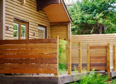 a wooden fence in front of a house at The Ferny Hoolet in Caton