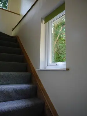 a staircase with a window in a house at The Ferny Hoolet in Caton