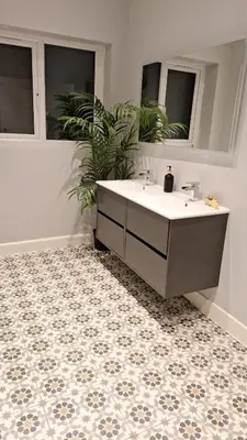 a bathroom with a tub and a sink and a tile floor at Victorian Suites Apartment in Southport