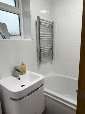 a white bathroom with a sink and a shower at Wigan 2-Bedroom Modern house - Cozy & Relaxing Stay in Bickershaw