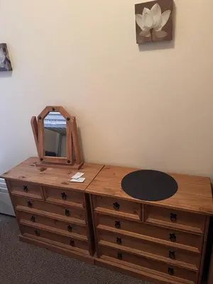 a wooden dresser with a mirror on top of it at Woodfield Lodge Apartments in Blackpool