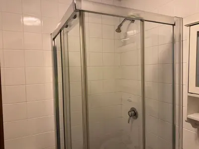 a shower with a glass door in a bathroom at Woodfield Lodge Apartments in Blackpool
