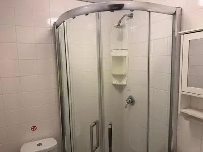 a shower with a glass door in a bathroom at Woodfield Lodge Apartments in Blackpool
