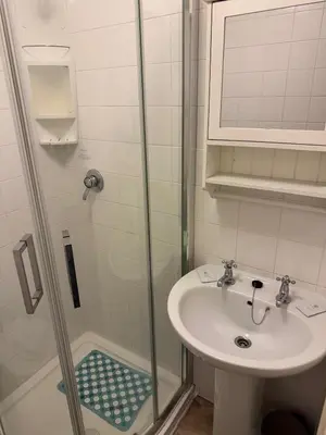 a bathroom with a sink and a shower at Woodfield Lodge Apartments in Blackpool