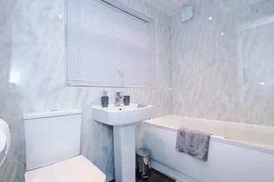 a bathroom with a sink and a toilet and a bath tub at Presented by LTJ PrimeKey Properties - NEW! 4 Bed plus Sofa Bed, Perfect for Contractors in Saint Helens