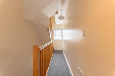 a hallway with a stairway with a window at Modern Family Home Near Liverpool City in Wallasey