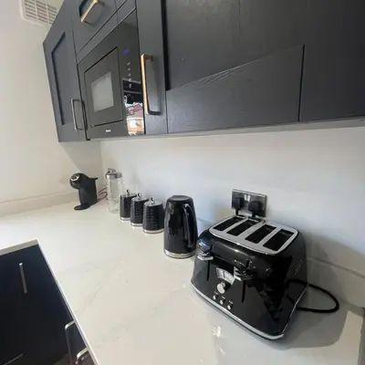 a kitchen counter with a toaster on a counter top at Stylish family home with cinema-style lounge near Blackpool in Blackpool