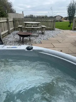 a swimming pool with a picnic table and a picnic table at Mill House Farm Pods - Lapwing Lodge in Pilling
