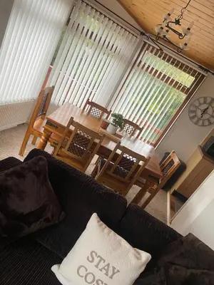 a living room with a couch and a table at Kingfisher Cosy Lakeside Lodge in Carnforth