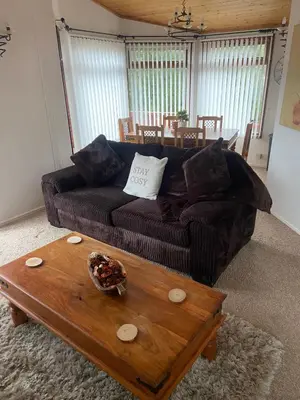 a living room with a couch and a coffee table at Kingfisher Cosy Lakeside Lodge in Carnforth