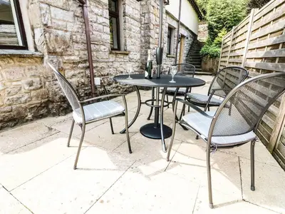 a table and chairs sitting on a patio at The Coach House in Carnforth