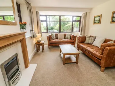 a living room with two couches and a fireplace at The Coach House in Carnforth