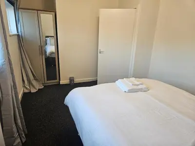 a hotel room with a white bed and a mirror at Relaxing and Comfort in Preston