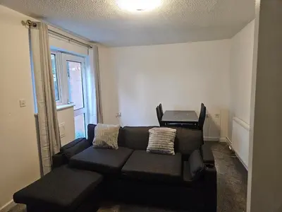 a living room with a couch and a table at Relaxing and Comfort in Preston
