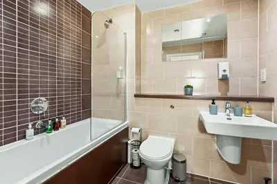 a bathroom with a toilet and a sink and a tub at Central Liverpool Baltic Apartment Sleeps 7 in Liverpool