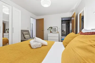 a bedroom with two beds with yellow sheets at Central Liverpool Baltic Apartment Sleeps 7 in Liverpool