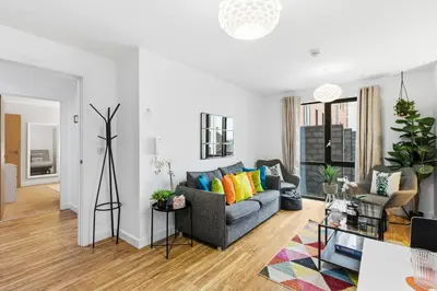 a living room with a couch and a table at Central Liverpool Baltic Apartment Sleeps 7 in Liverpool