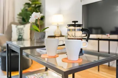 a coffee maker and two cups on a glass table at Central Liverpool Baltic Apartment Sleeps 7 in Liverpool