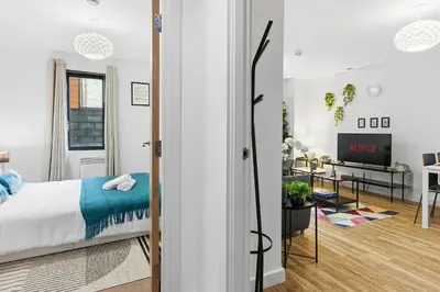 a bedroom with a bed and a living room at Central Liverpool Baltic Apartment Sleeps 7 in Liverpool