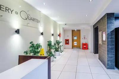 a hallway with potted plants in a lobby at Central Liverpool Baltic Apartment Sleeps 7 in Liverpool