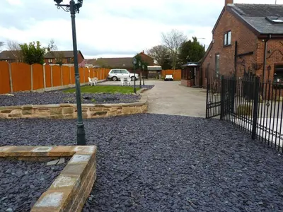 a street light next to a building with a fence at Smithy lodge guest house in Leyland