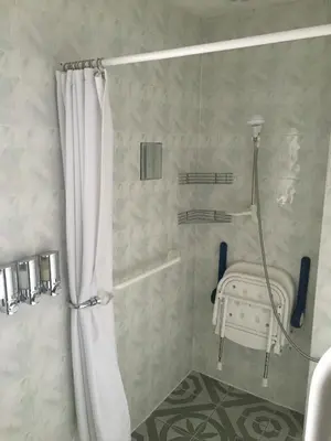 a shower with a shower curtain in a bathroom at Smithy lodge guest house in Leyland