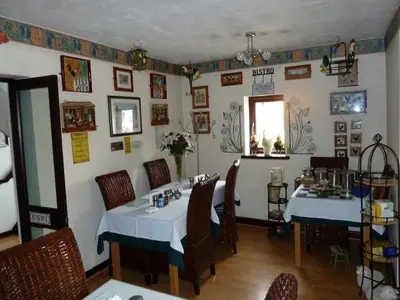a dining room with two tables in a restaurant at Smithy lodge guest house in Leyland