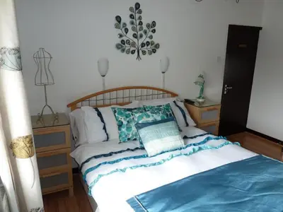 a bedroom with a bed with a wooden headboard at Smithy lodge guest house in Leyland