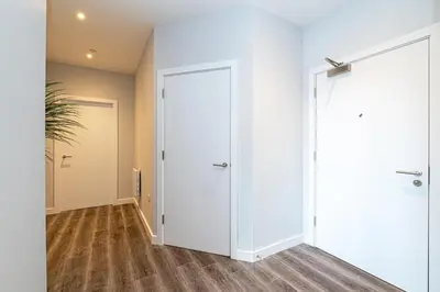 an empty hallway with white walls and a door at #94 Lux Crosby Gardens Apartment 2 beds 2 baths in Waterloo
