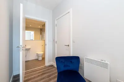 a blue chair in a room with a bathroom at #94 Lux Crosby Gardens Apartment 2 beds 2 baths in Waterloo