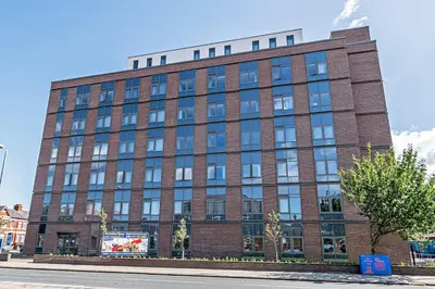 a large brick building on a city street at #94 Lux Crosby Gardens Apartment 2 beds 2 baths in Waterloo