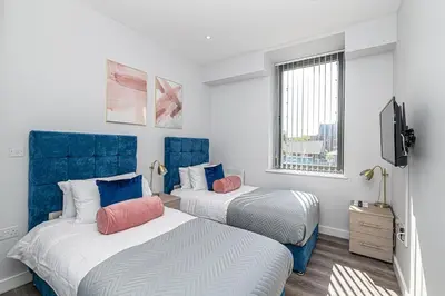 a bedroom with two beds with blue headboards at #94 Lux Crosby Gardens Apartment 2 beds 2 baths in Waterloo