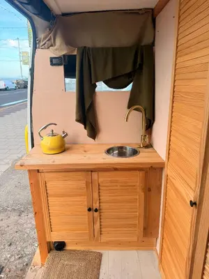 a sink on a wooden table in a camper at Sea View Camper Van in Blackpool
