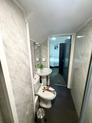 a bathroom with a toilet and a sink and a mirror at Home in Preston City Center in Preston