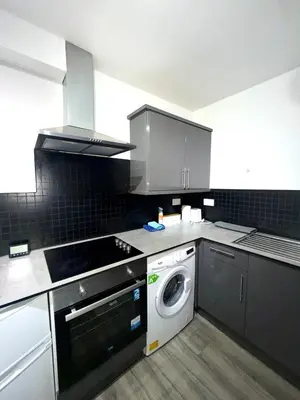 a kitchen with a washing machine and a washer at Home in Preston City Center in Preston