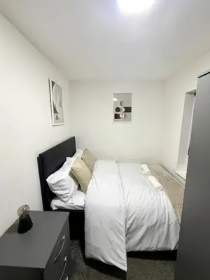 a small bedroom with a bed and a desk at Home in Preston City Center in Preston