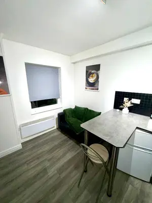 a living room with a table and a couch at Home in Preston City Center in Preston